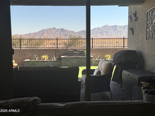 interior space with outdoor lounge area and a mountain view