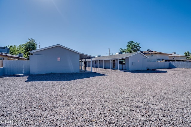 rear view of house featuring fence
