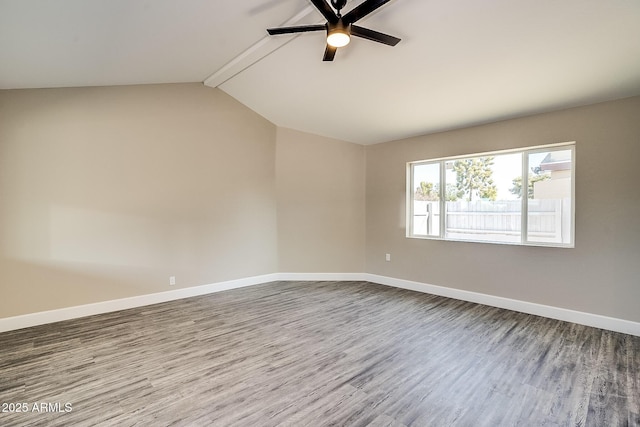 empty room with ceiling fan, dark wood finished floors, and baseboards
