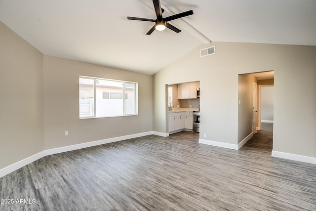 unfurnished living room with light wood finished floors, ceiling fan, beam ceiling, baseboards, and high vaulted ceiling