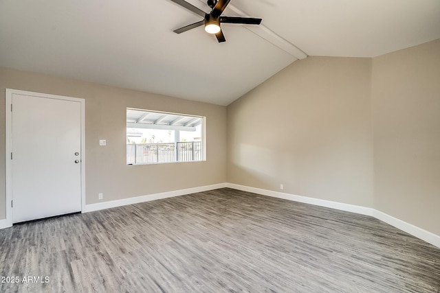 unfurnished living room featuring a ceiling fan, wood finished floors, and baseboards