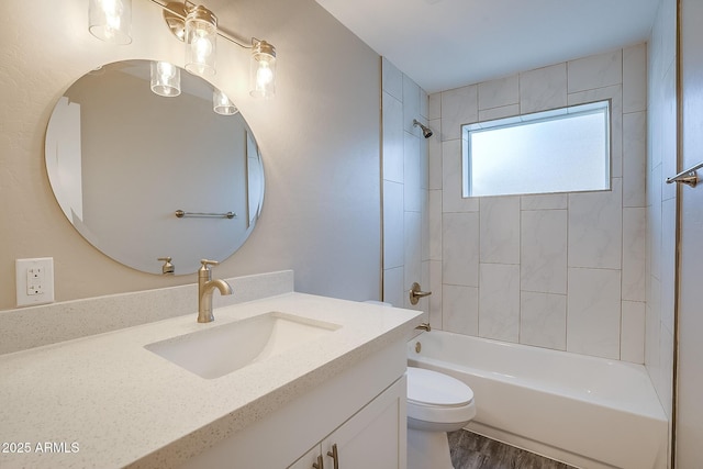 full bath featuring toilet, vanity, shower / bath combination, and wood finished floors