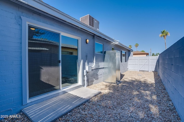 view of property exterior with a fenced backyard and concrete block siding