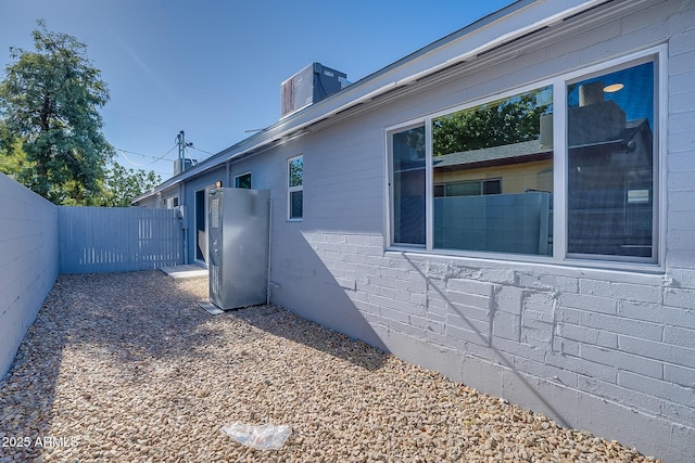 view of property exterior featuring fence and a chimney