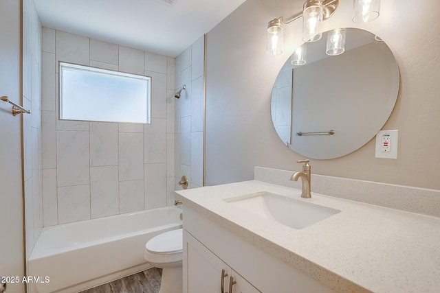 full bath featuring toilet, vanity, shower / bathtub combination, and wood finished floors