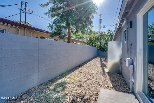 view of side of property with a fenced backyard