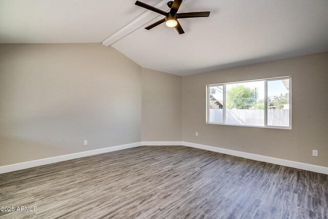 unfurnished room featuring dark wood-type flooring, a ceiling fan, and baseboards