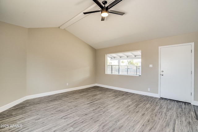 empty room with wood finished floors, a ceiling fan, and baseboards