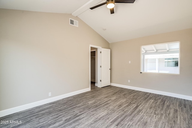 spare room featuring wood finished floors, a ceiling fan, beam ceiling, baseboards, and high vaulted ceiling
