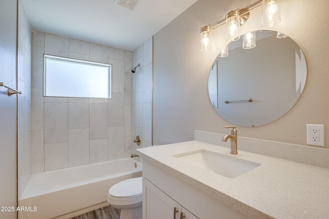 bathroom with toilet, vanity, and bathing tub / shower combination