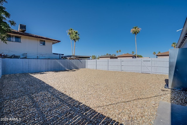 fenced backyard with cooling unit