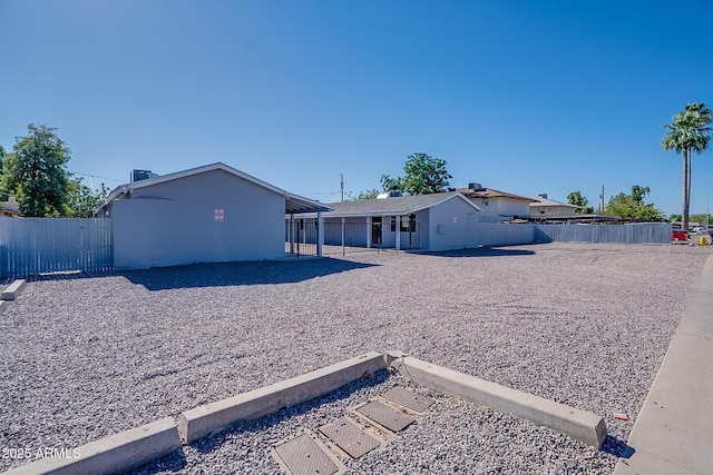 rear view of property with a fenced backyard