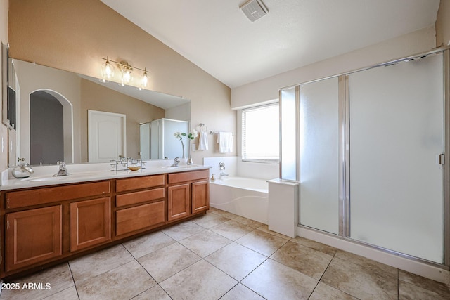 bathroom with tile patterned floors, a sink, lofted ceiling, and visible vents
