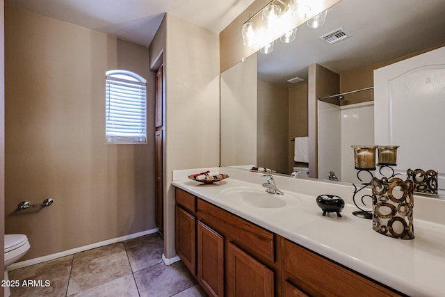 bathroom featuring vanity, baseboards, tile patterned floors, toilet, and visible vents