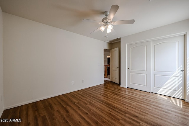 unfurnished bedroom with a closet, baseboards, a ceiling fan, and wood finished floors