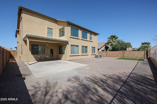 back of property featuring central air condition unit, a patio, a fenced backyard, and stucco siding