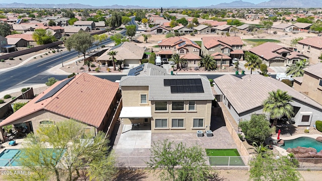 birds eye view of property with a mountain view and a residential view