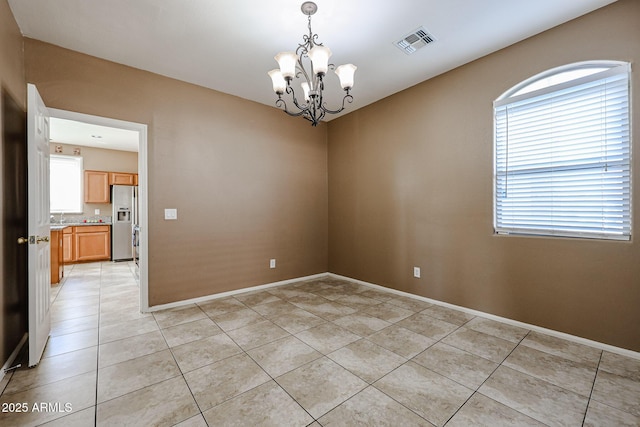 unfurnished room featuring visible vents, baseboards, a chandelier, and light tile patterned floors