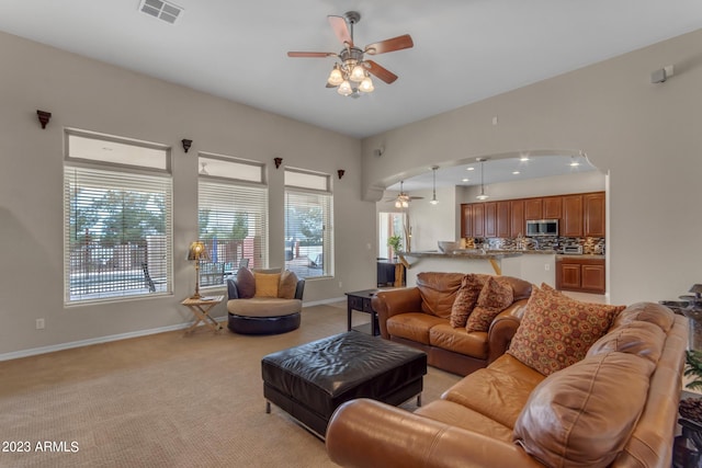 carpeted living room featuring ceiling fan