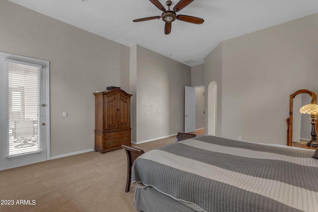 carpeted bedroom with ceiling fan and vaulted ceiling