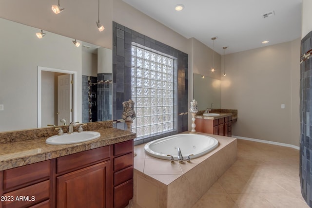 bathroom featuring vanity, shower with separate bathtub, a healthy amount of sunlight, and tile patterned floors