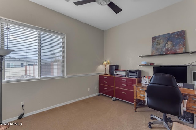 carpeted office space featuring ceiling fan