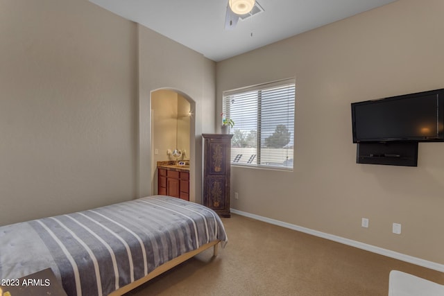 bedroom featuring ensuite bathroom, carpet floors, and ceiling fan