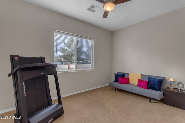 workout room featuring ceiling fan and light colored carpet