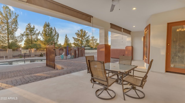 view of patio / terrace with a fenced in pool and ceiling fan