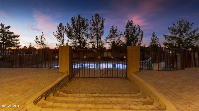 exterior space featuring a fenced in pool and a patio