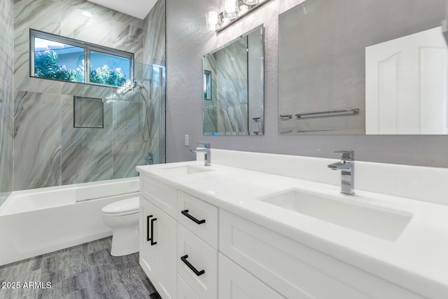 full bathroom with toilet, vanity, tiled shower / bath combo, and hardwood / wood-style flooring