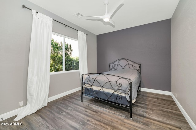 bedroom with ceiling fan and dark wood-type flooring