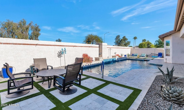 view of swimming pool featuring pool water feature and a patio area