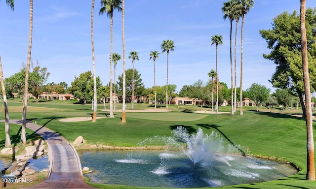 view of community featuring a yard and a water view