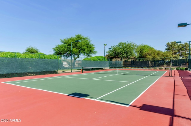 view of tennis court with basketball hoop