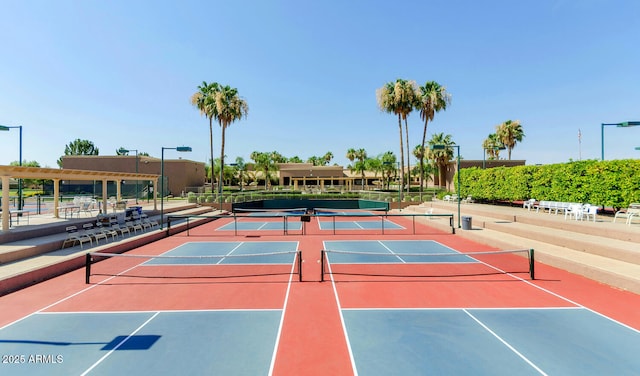 view of tennis court featuring basketball hoop