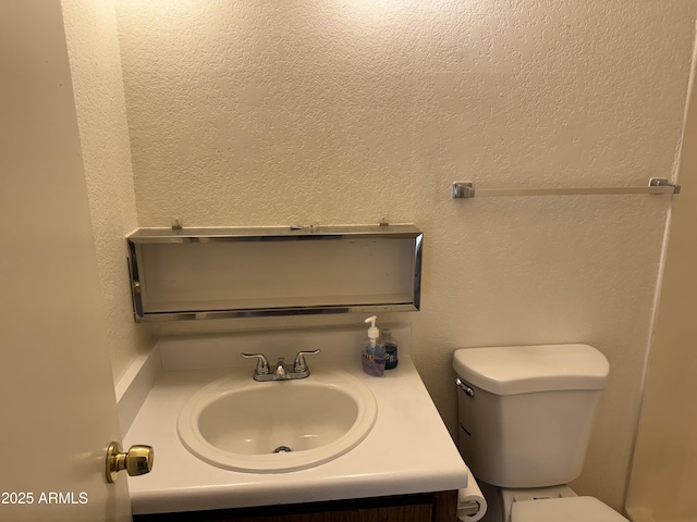 bathroom with toilet and vanity