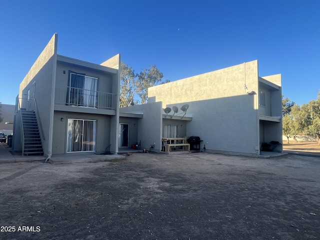 rear view of property with a balcony