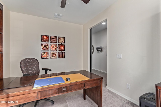 carpeted office space with ceiling fan