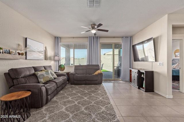 tiled living room with ceiling fan