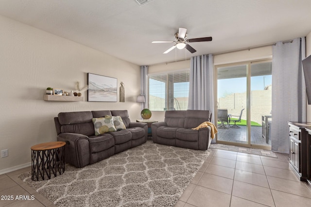 living room with ceiling fan and light tile patterned flooring