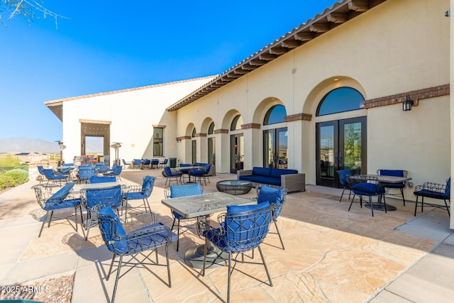 view of patio / terrace with a mountain view and an outdoor hangout area