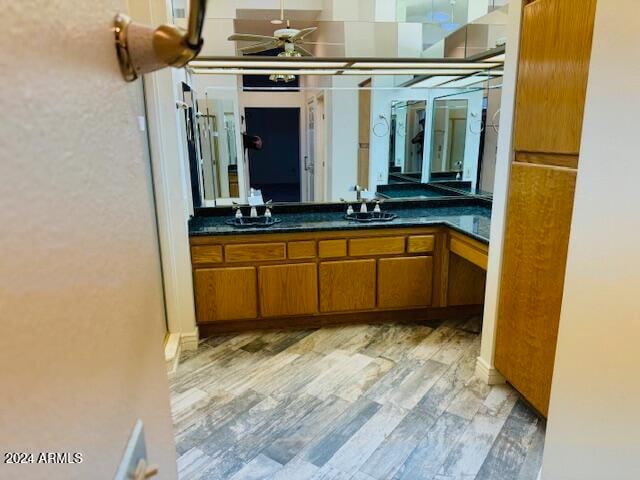 bathroom with vanity, hardwood / wood-style flooring, and ceiling fan