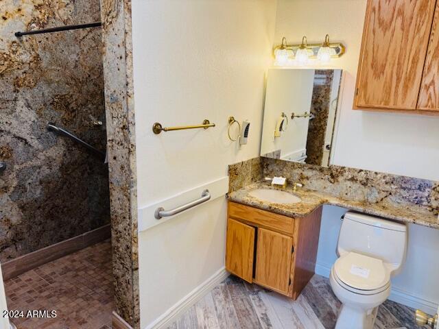 bathroom featuring hardwood / wood-style floors, vanity, and toilet