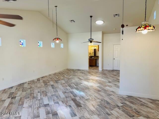 interior space featuring hardwood / wood-style flooring, high vaulted ceiling, and ceiling fan