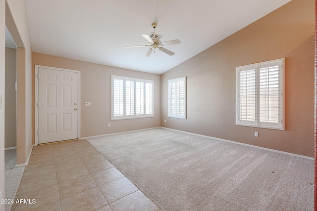 carpeted empty room with ceiling fan and vaulted ceiling