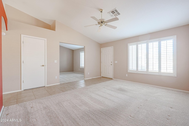 unfurnished room featuring ceiling fan, light carpet, and vaulted ceiling