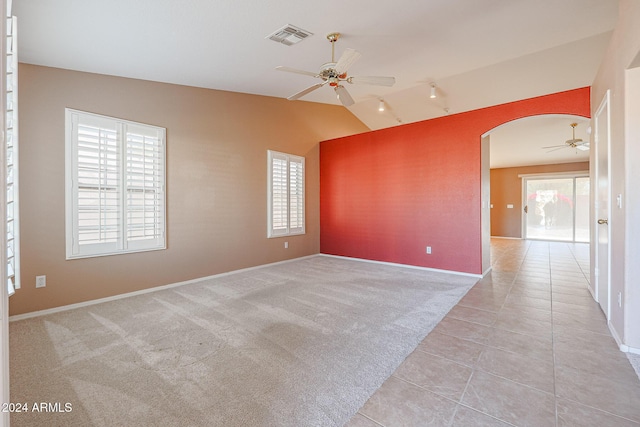 7275 W Tina Ln, Glendale, AZ 85310 - spare room featuring a ceiling fan, arched walkways, plenty of natural light, rail lighting, and vaulted ceiling