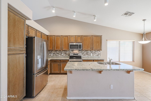 7275 W Tina Ln, Glendale, AZ 85310 - kitchen with appliances with stainless steel finishes, lofted ceiling, light tile patterned flooring, brown cabinets, and tasteful backsplash