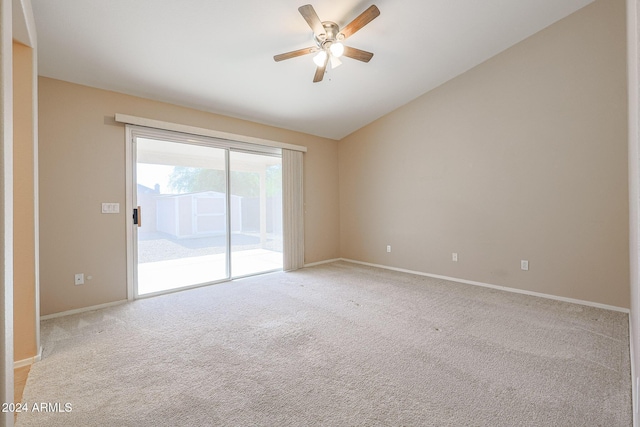 carpeted empty room featuring ceiling fan and vaulted ceiling